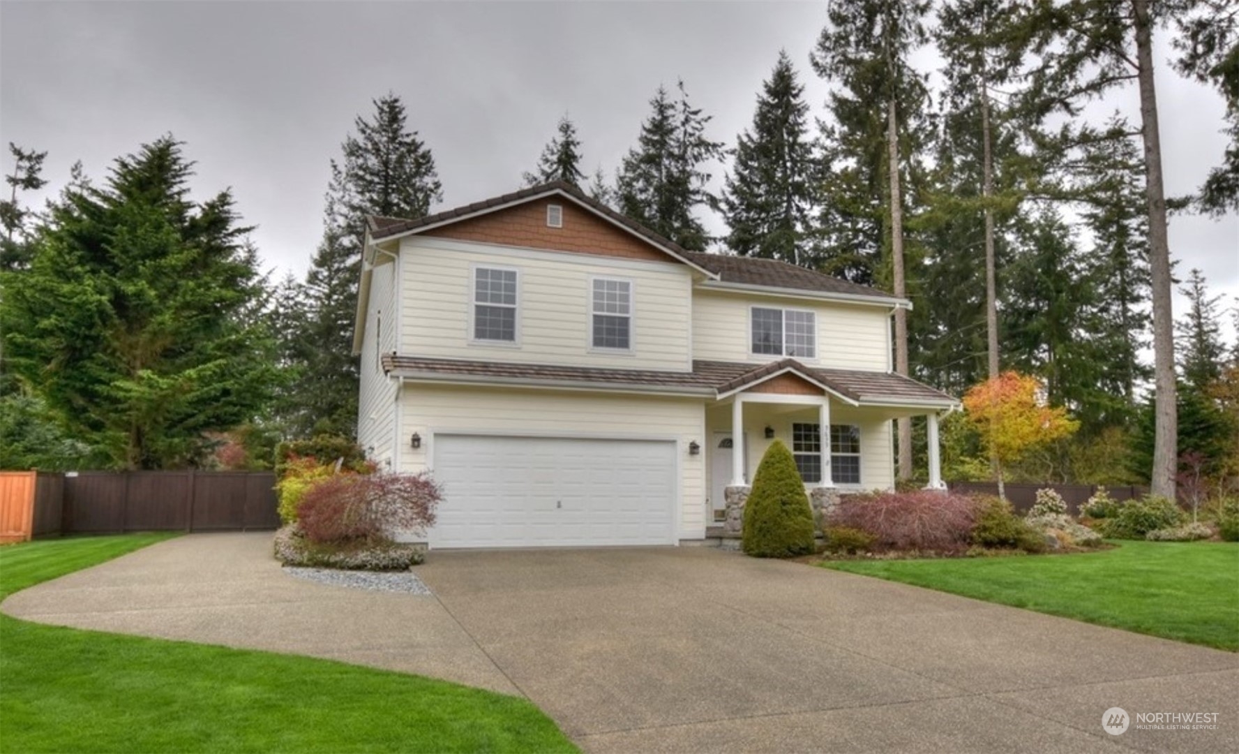 9639 39th Loop Northeast Olympia, WA 98516 - Photo 22 of 38 a front view of a house with a yard and garage