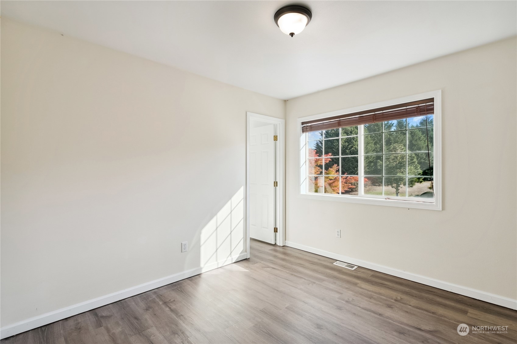 9639 39th Loop Northeast Olympia, WA 98516 - Photo 25 of 38 an empty room with wooden floor and windows