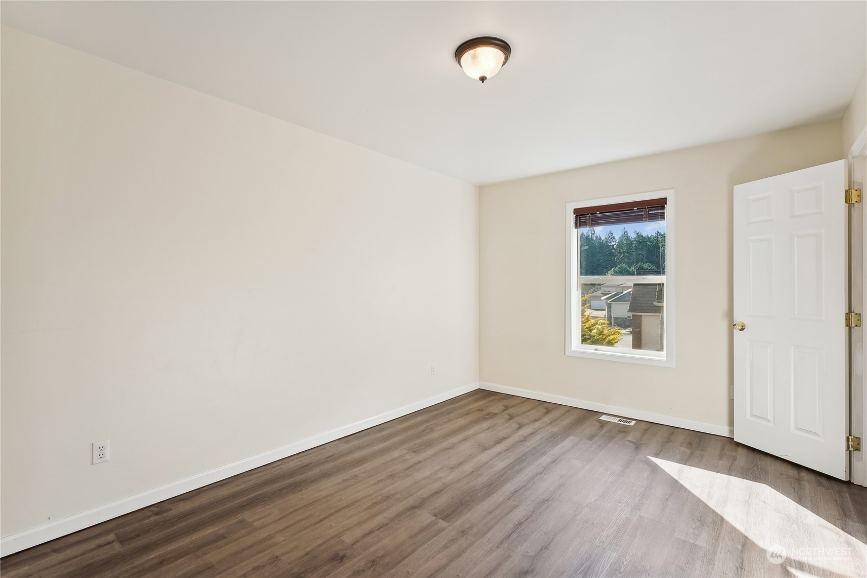 9639 39th Loop Northeast Olympia, WA 98516 - Photo 28 of 38 an empty room with wooden floor and windows