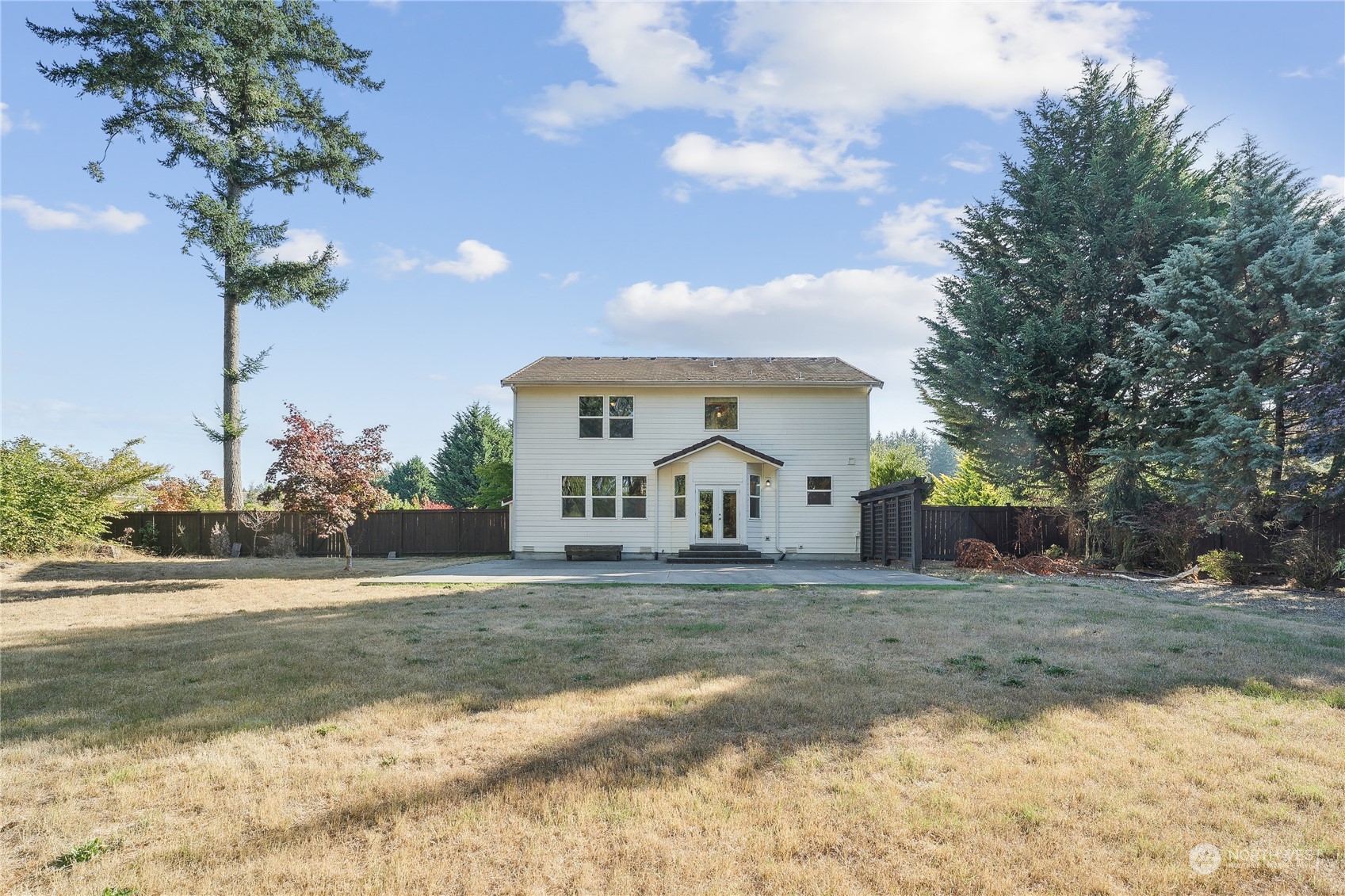 9639 39th Loop Northeast Olympia, WA 98516 - Photo 3 of 38 a front view of a house with a yard and garage
