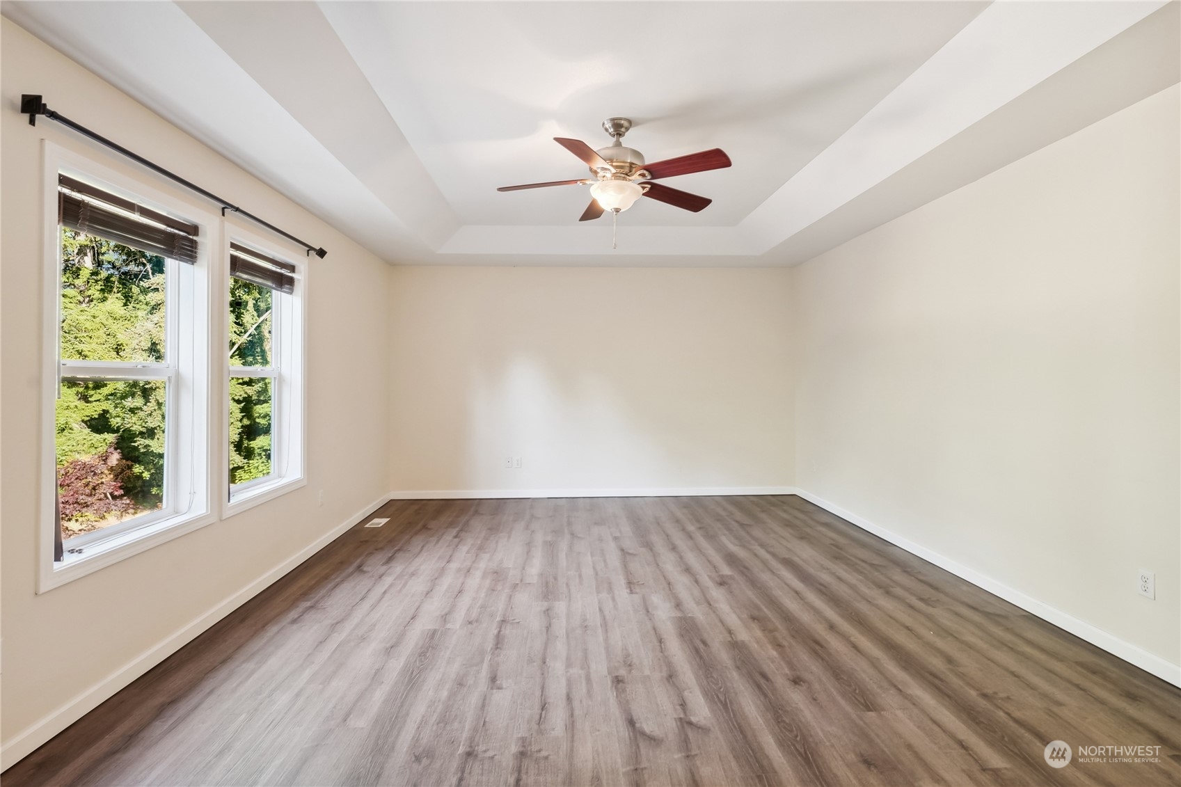 9639 39th Loop Northeast Olympia, WA 98516 - Photo 36 of 38 an empty room with wooden floor fan and windows