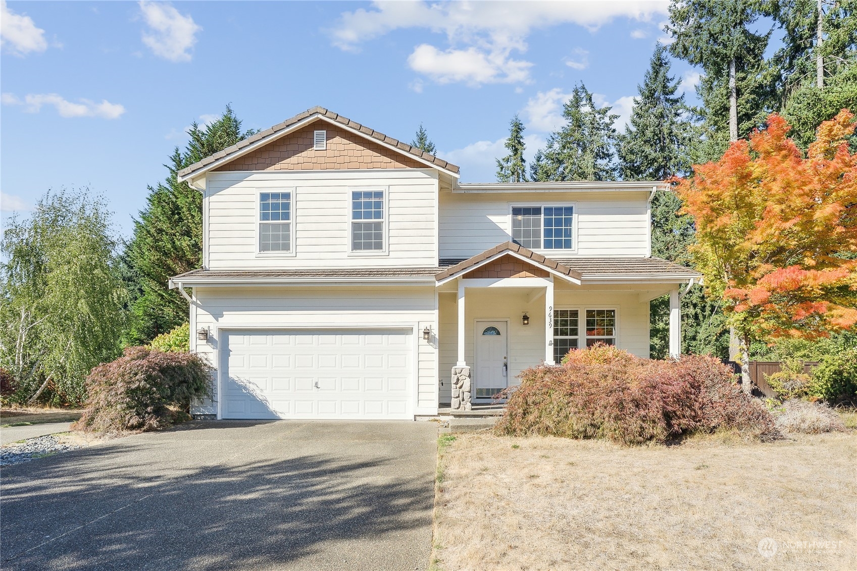 9639 39th Loop Northeast Olympia, WA 98516 - Photo 5 of 38 a front view of a house with a yard and garage