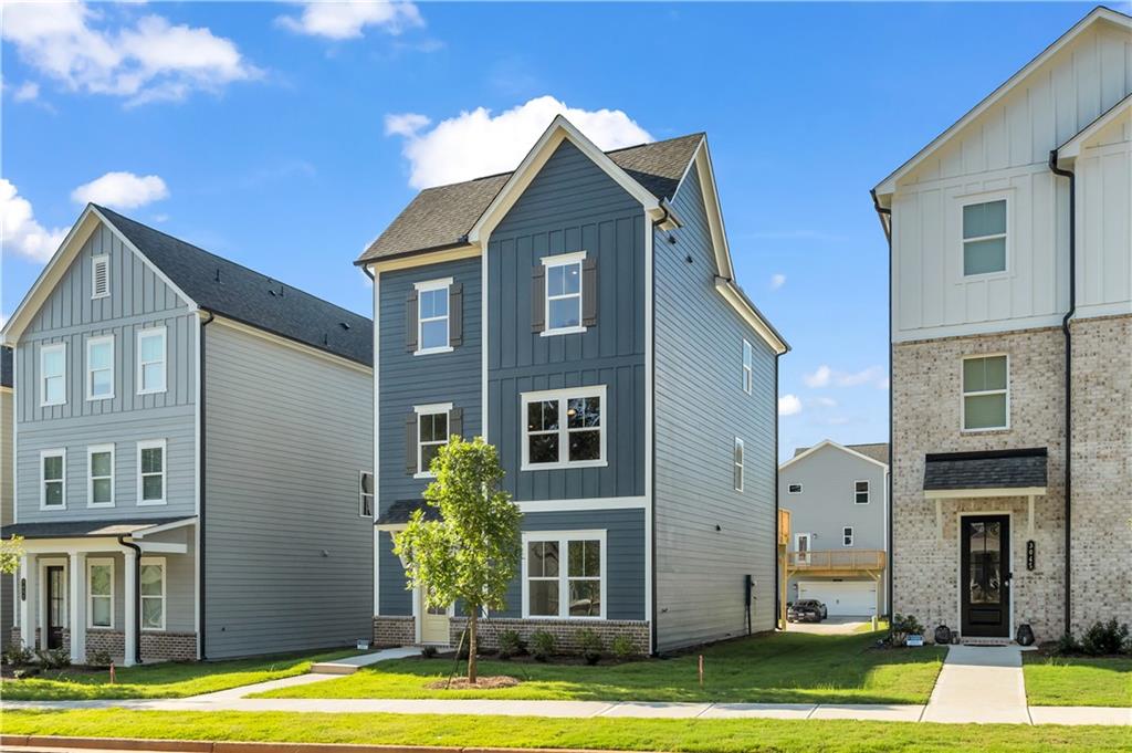 668 Devon Alley Acworth, GA 30102 - Photo 2 of 38 a front view of a residential apartment building with a yard