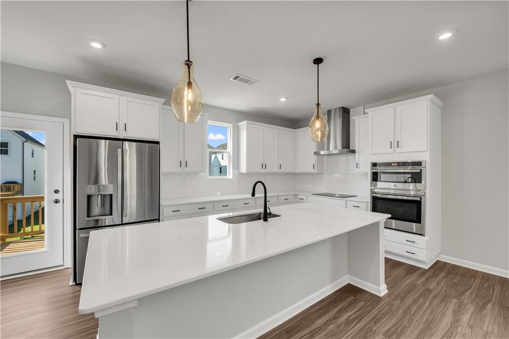 668 Devon Alley Acworth, GA 30102 - Photo 21 of 38 a kitchen with kitchen island a sink stainless steel appliances and cabinets
