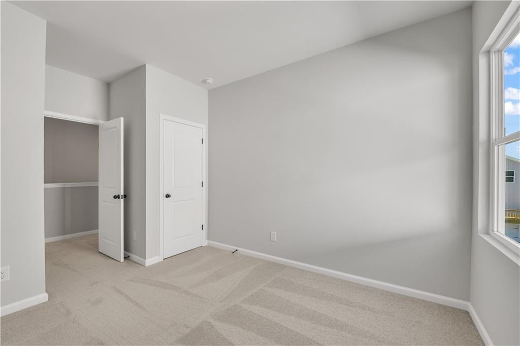 668 Devon Alley Acworth, GA 30102 - Photo 34 of 38 an empty room with windows and closet