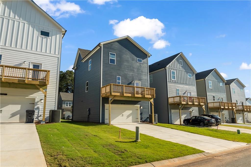 668 Devon Alley Acworth, GA 30102 - Photo 5 of 38 a front view of a house with a yard and garage