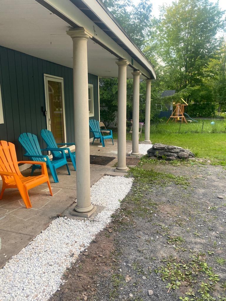 111 Spring Street Tannersville, NY 12485 - Photo 7 of 9 a view of a house with backyard porch and sitting area