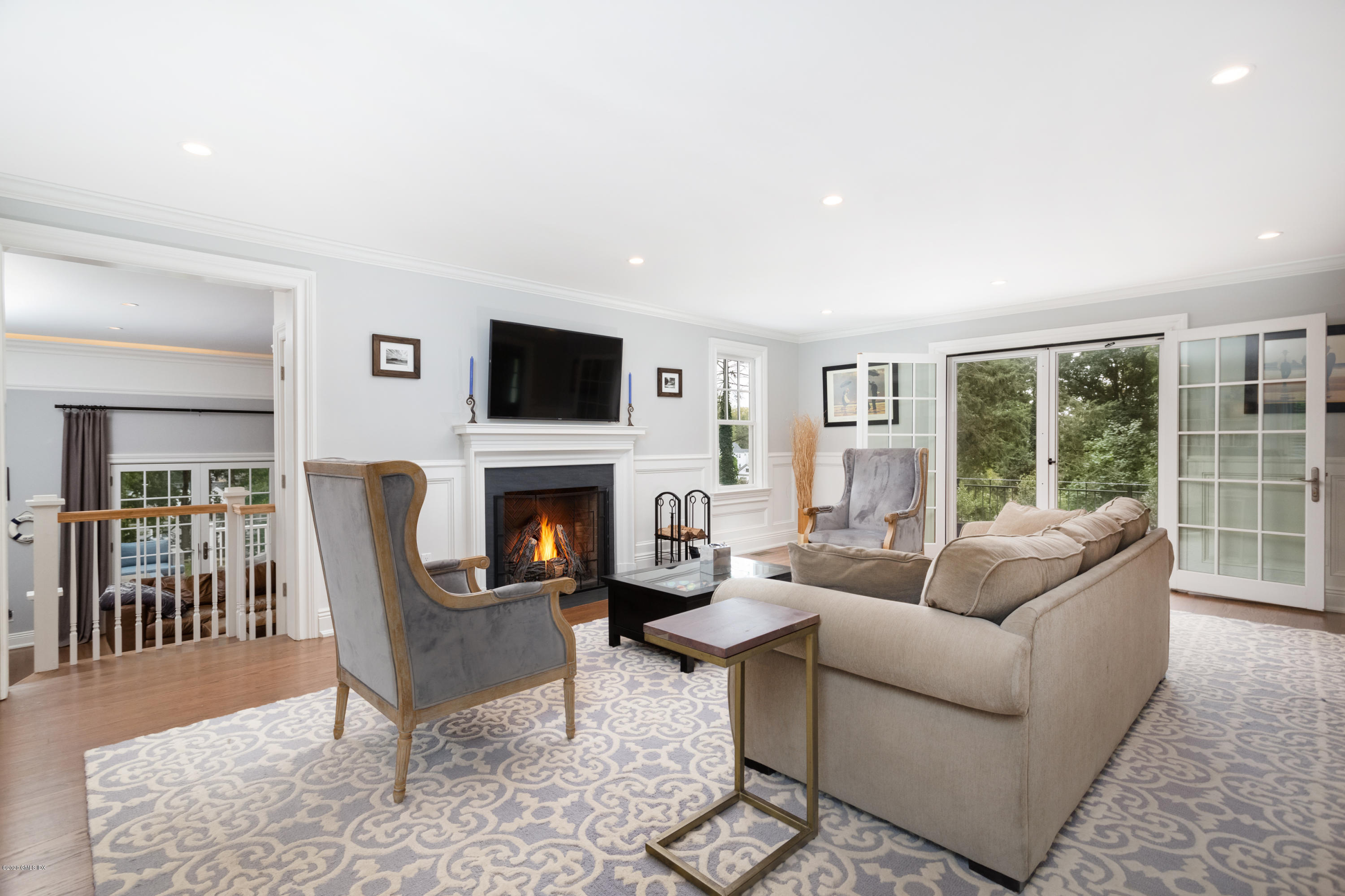 36 Evergreen Road Greenwich, CT 06830 - Photo 15 of 40 a living room with furniture a fireplace and a flat screen tv
