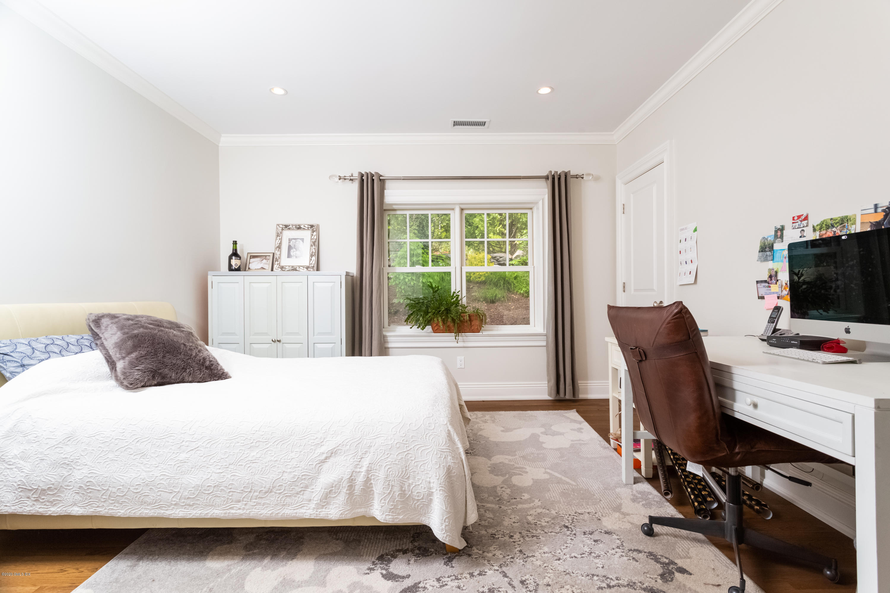 36 Evergreen Road Greenwich, CT 06830 - Photo 19 of 40 a bedroom with a large bed and a flat tv screen on the dresser