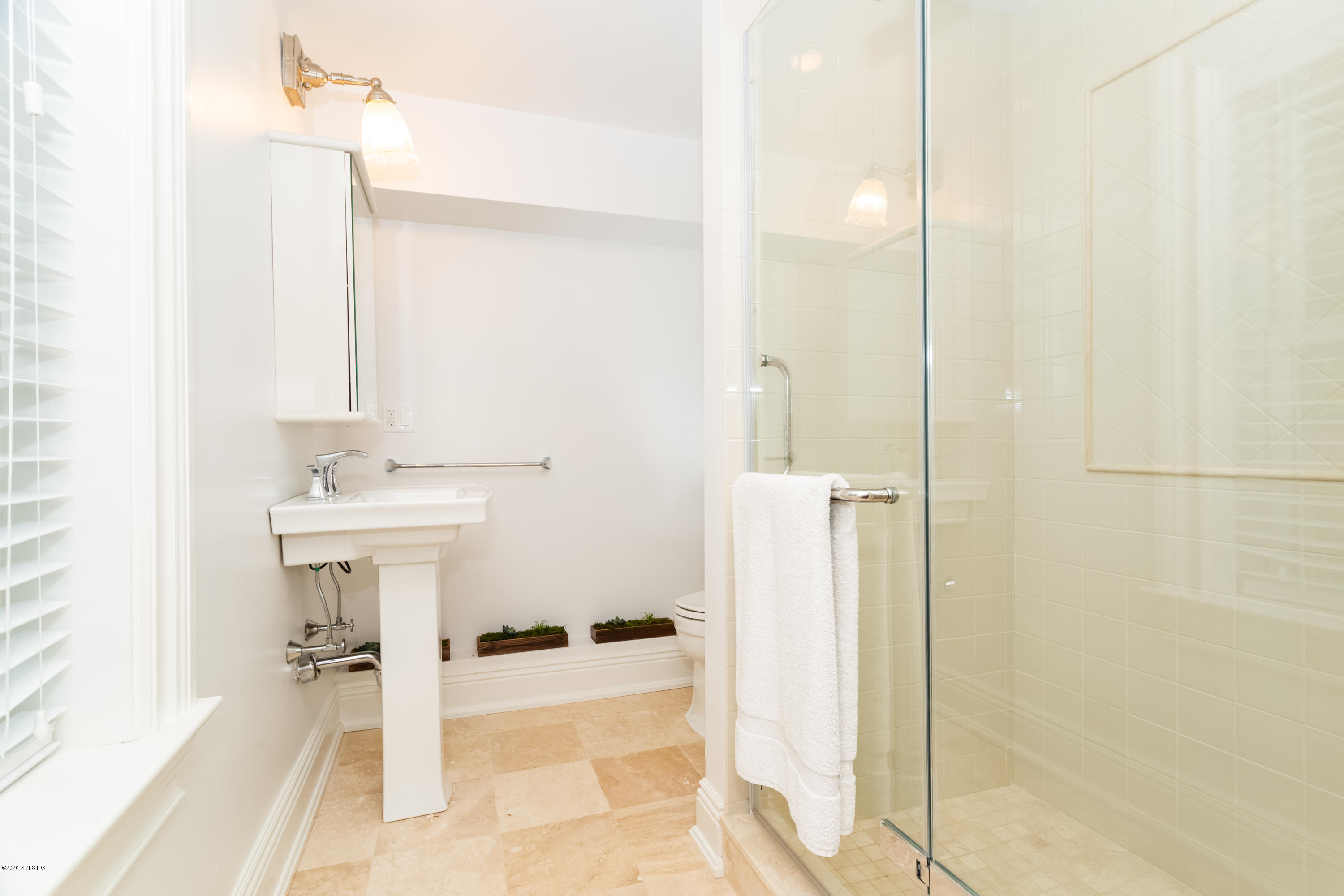 36 Evergreen Road Greenwich, CT 06830 - Photo 20 of 40 a bathroom with a sink a mirror and a shower