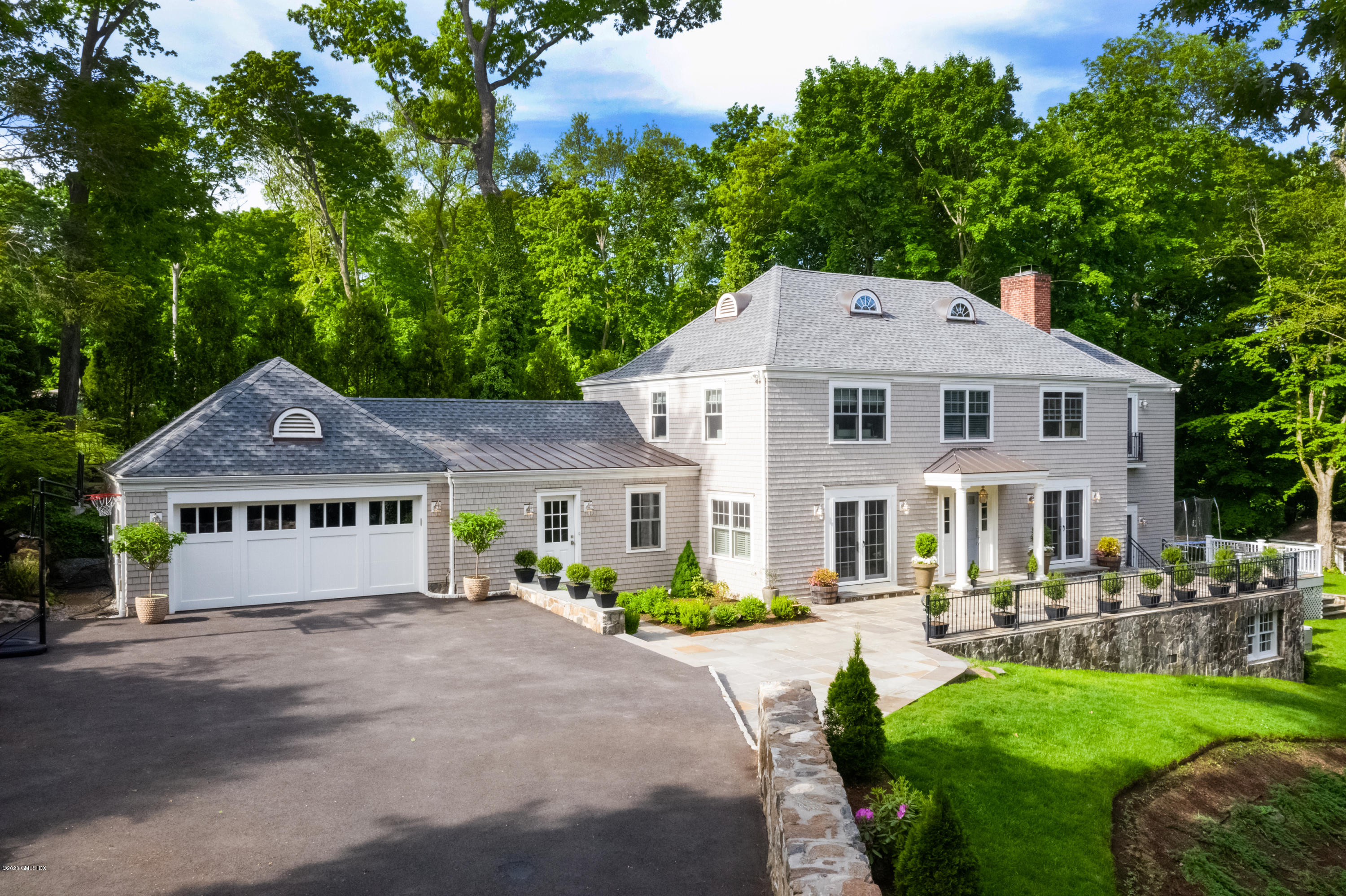 36 Evergreen Road Greenwich, CT 06830 - Photo 2 of 40 a front view of a house with garden and trees