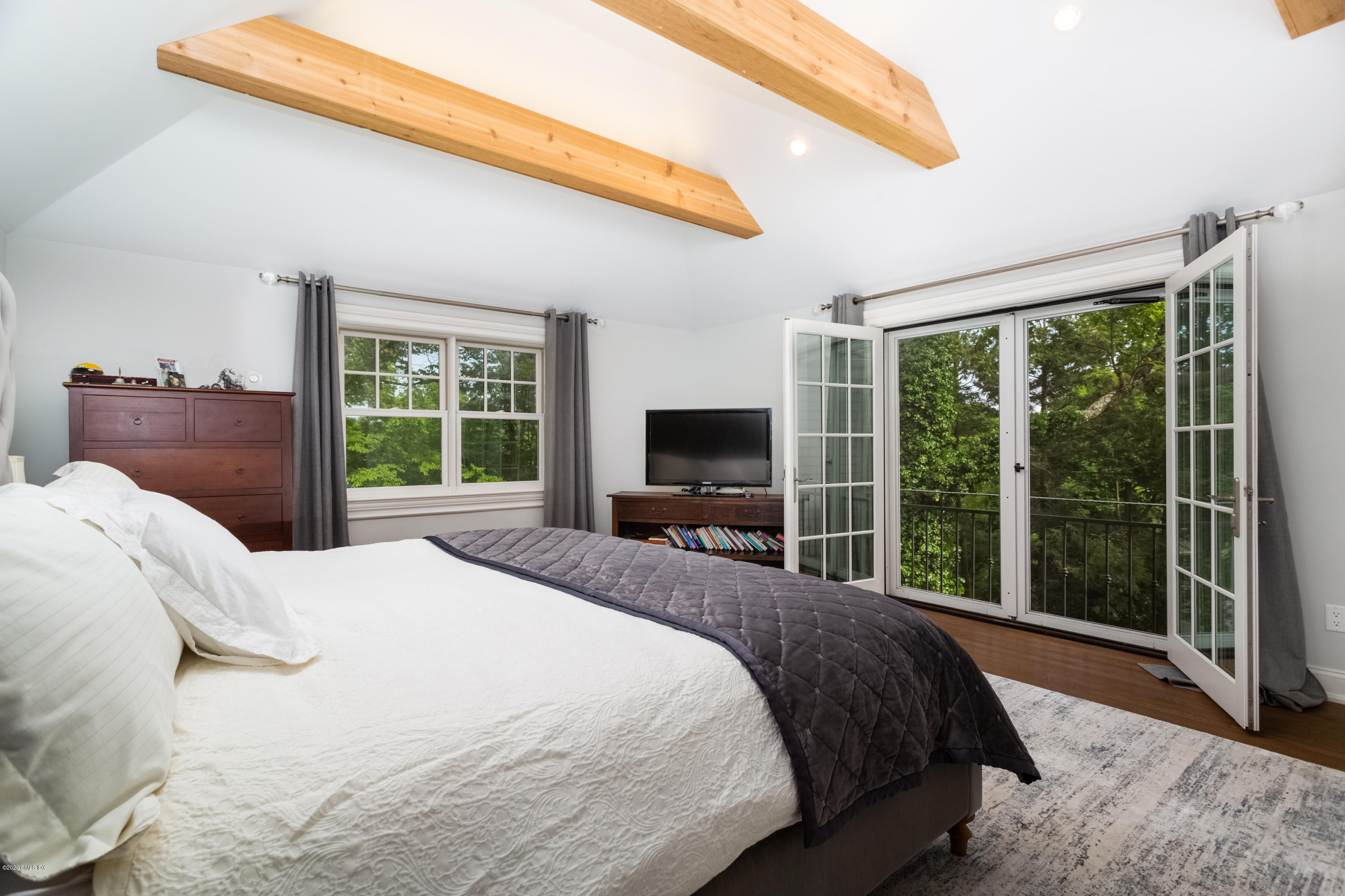 36 Evergreen Road Greenwich, CT 06830 - Photo 23 of 40 a bedroom with a balcony a bed and a television