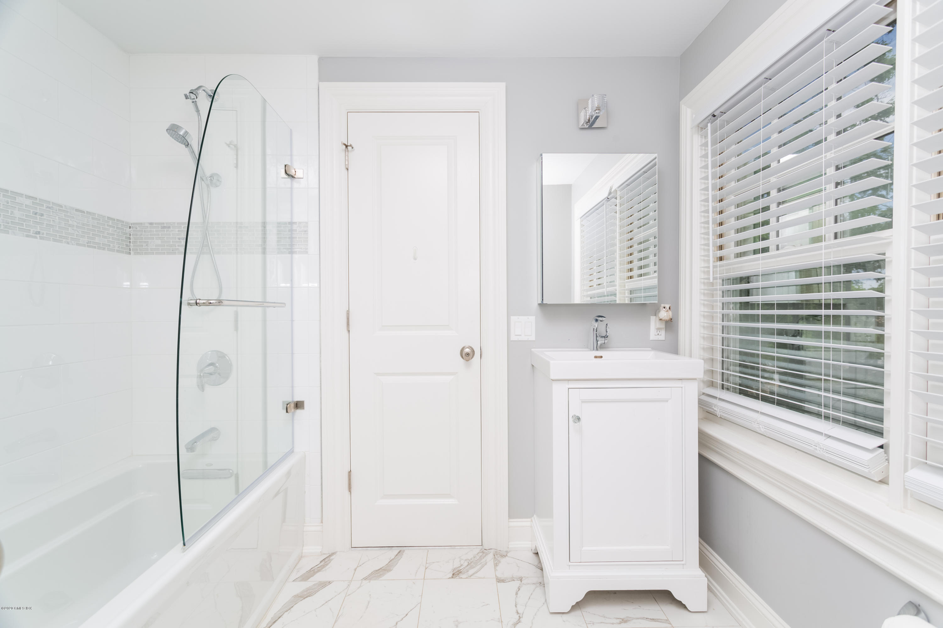 36 Evergreen Road Greenwich, CT 06830 - Photo 27 of 40 a bathroom with a shower sink and mirror
