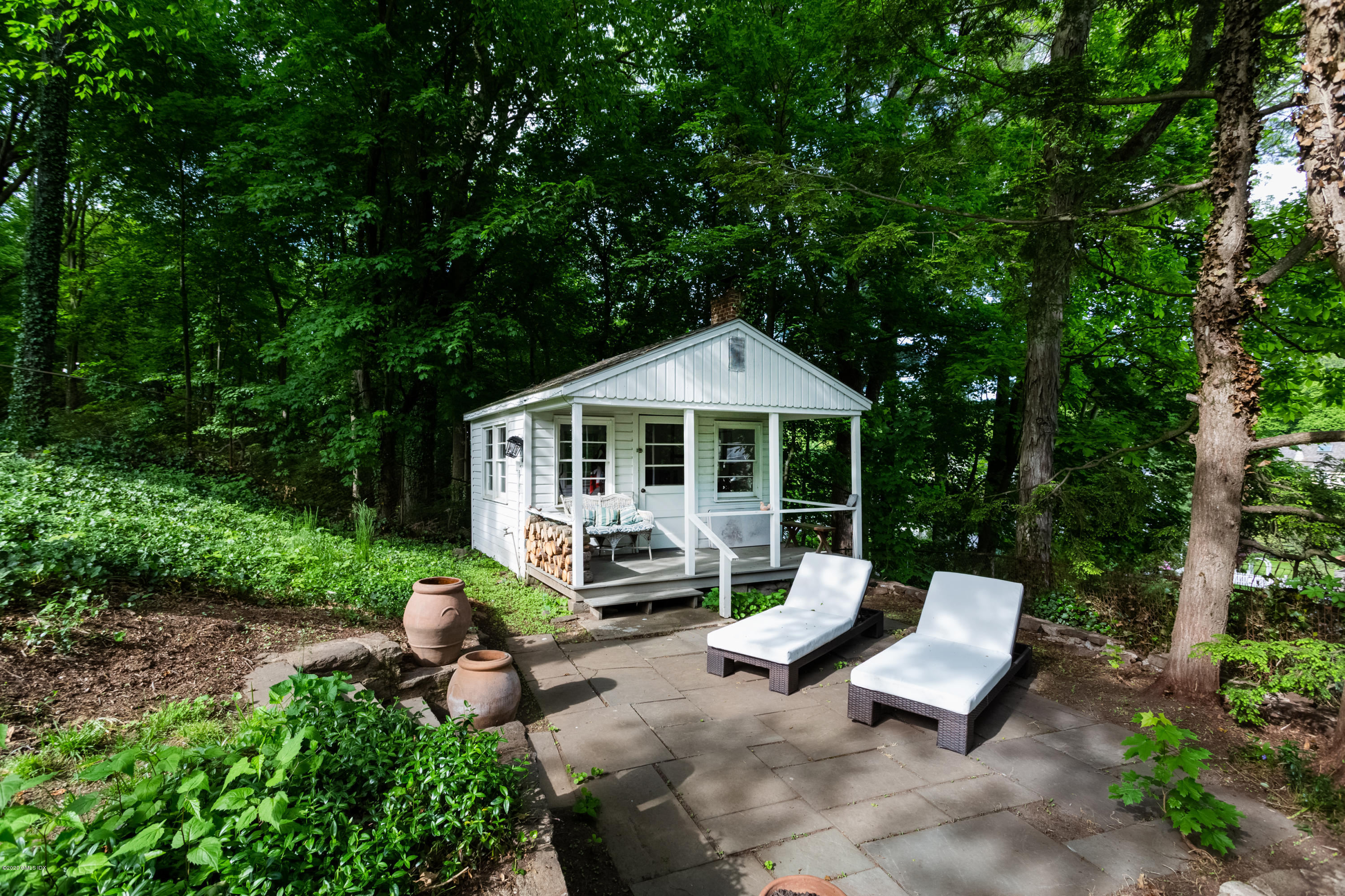 36 Evergreen Road Greenwich, CT 06830 - Photo 31 of 40 a view of a house with backyard sitting area and garden