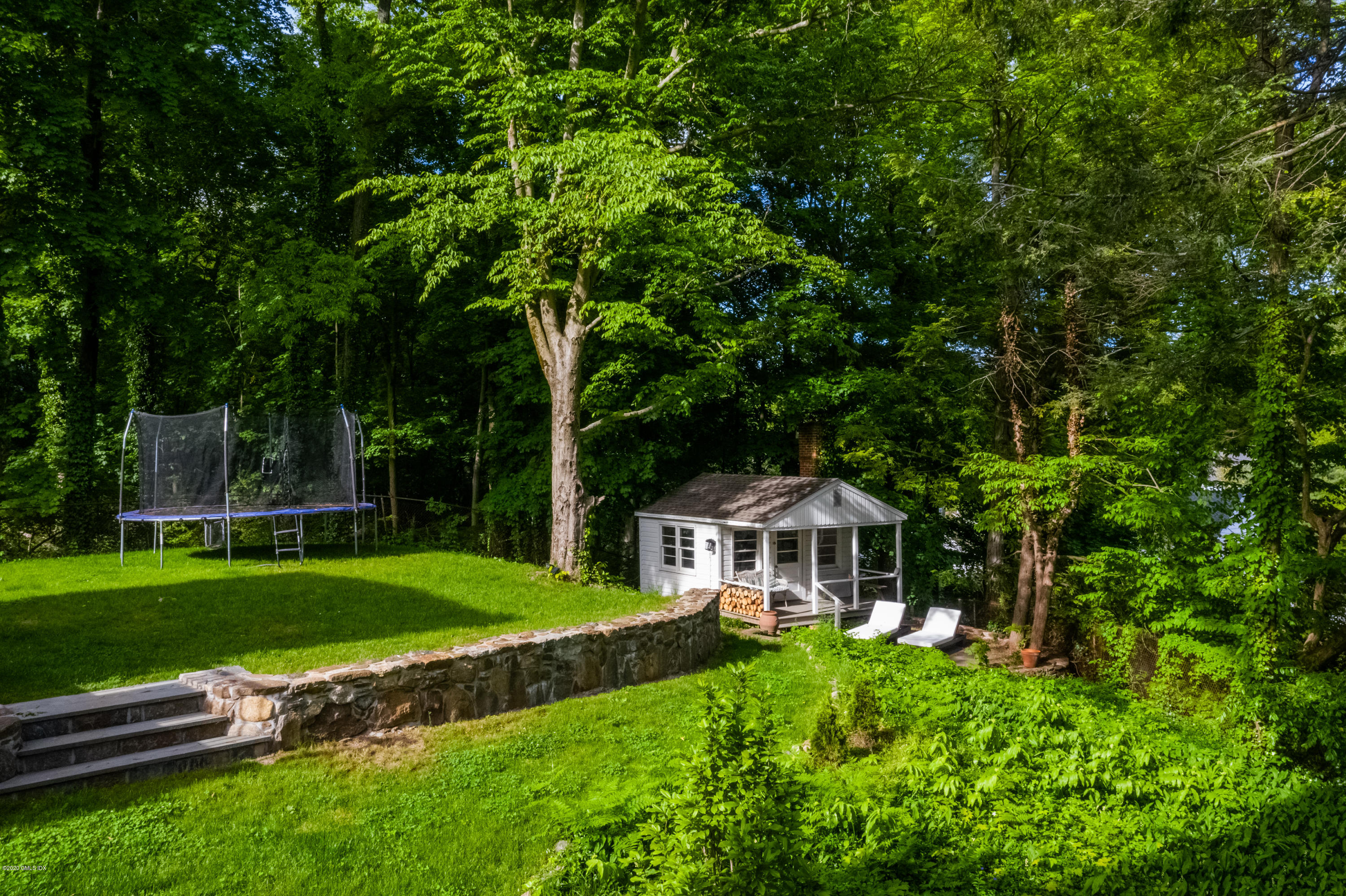 36 Evergreen Road Greenwich, CT 06830 - Photo 32 of 40 a front view of a house with a garden