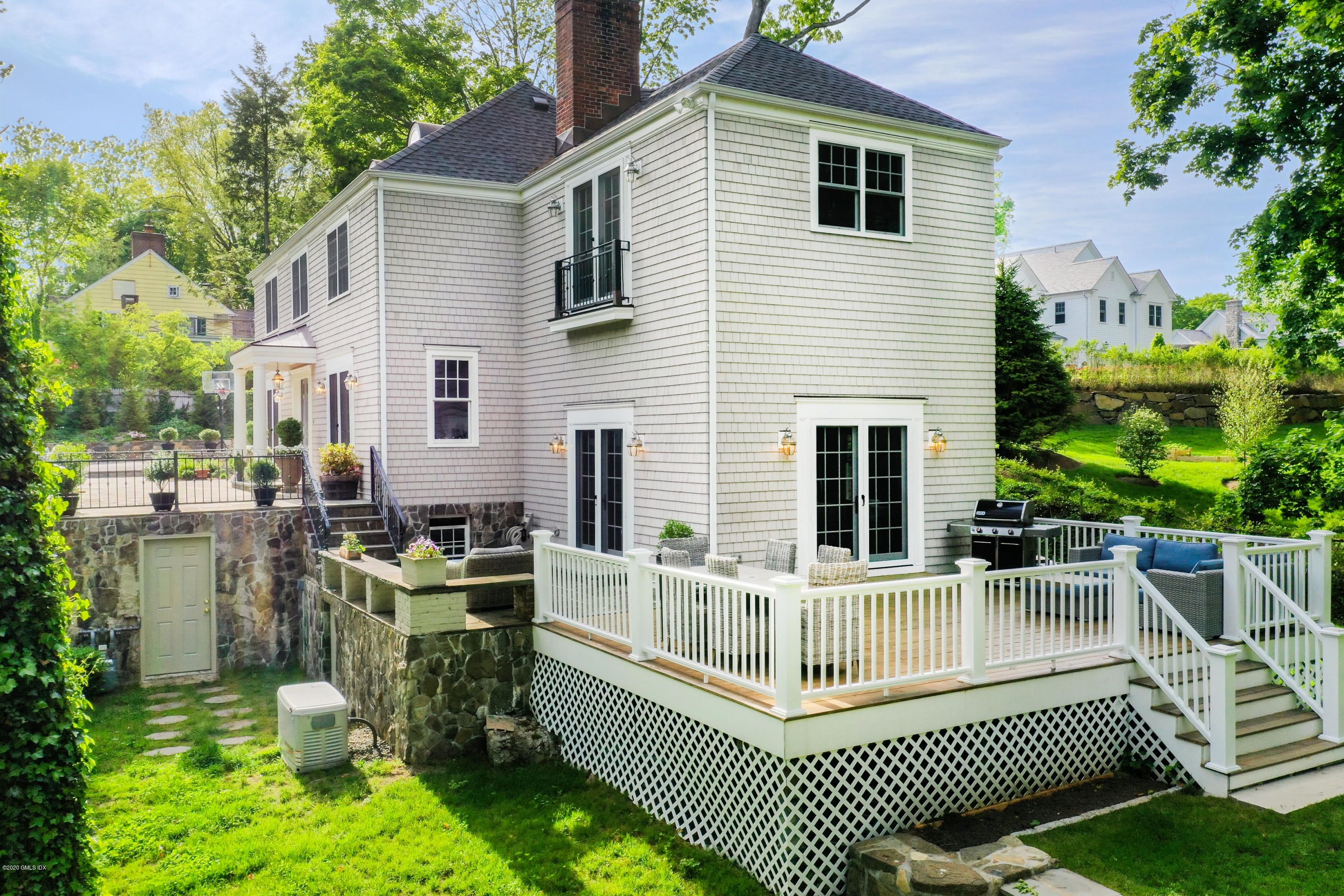 36 Evergreen Road Greenwich, CT 06830 - Photo 34 of 40 a view of a house with a chairs in patio