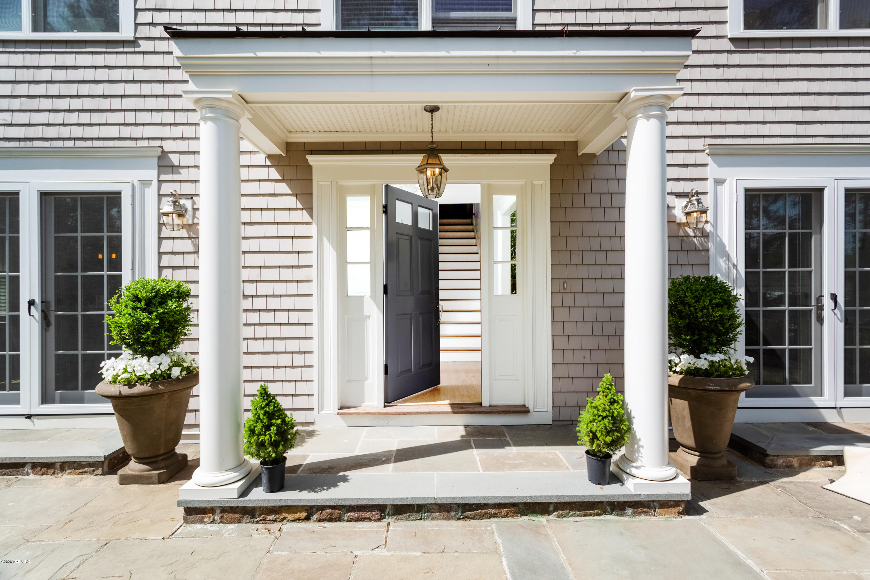 36 Evergreen Road Greenwich, CT 06830 - Photo 4 of 40 a front view of a house with plants
