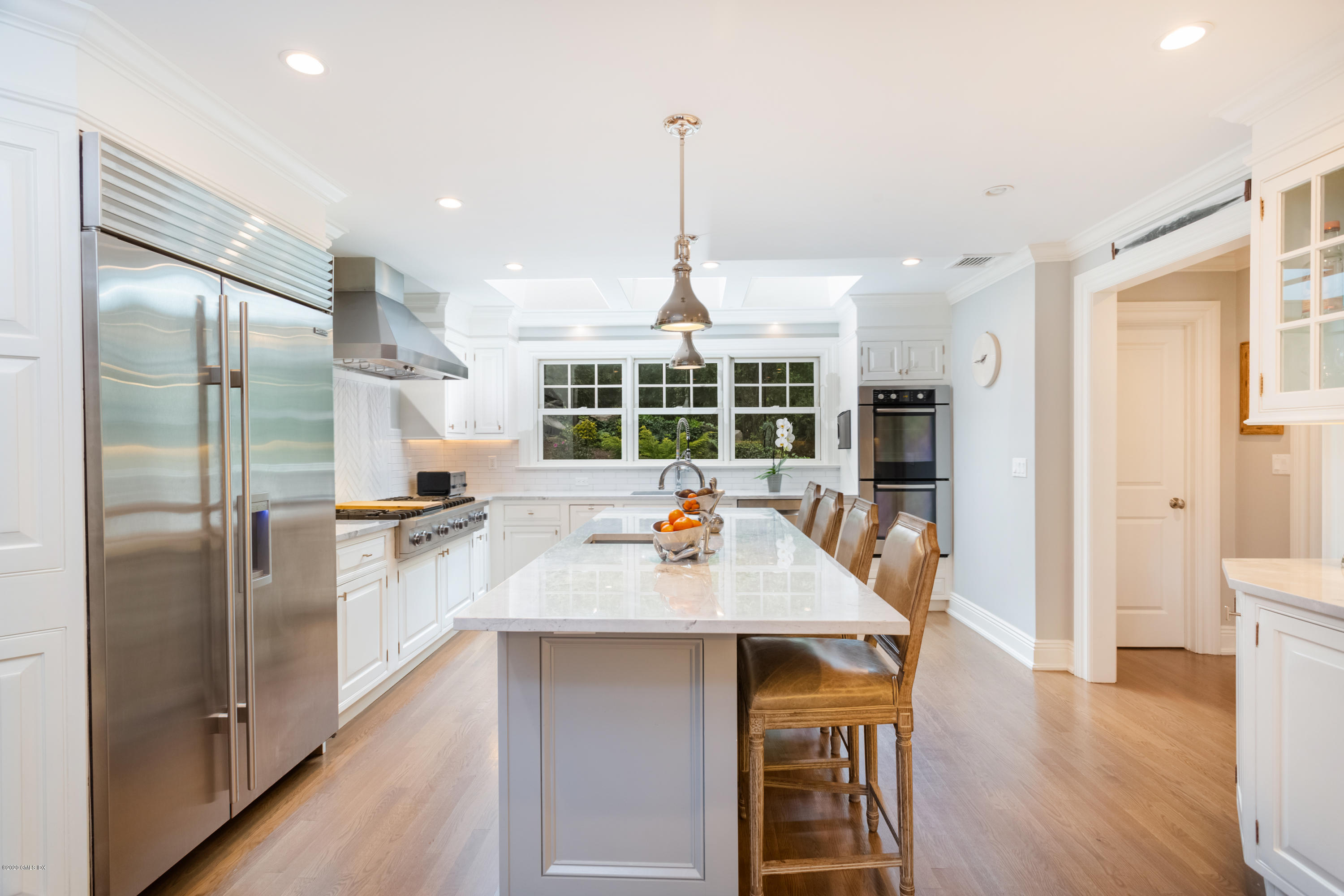 36 Evergreen Road Greenwich, CT 06830 - Photo 9 of 40 a kitchen with refrigerator a sink and chairs