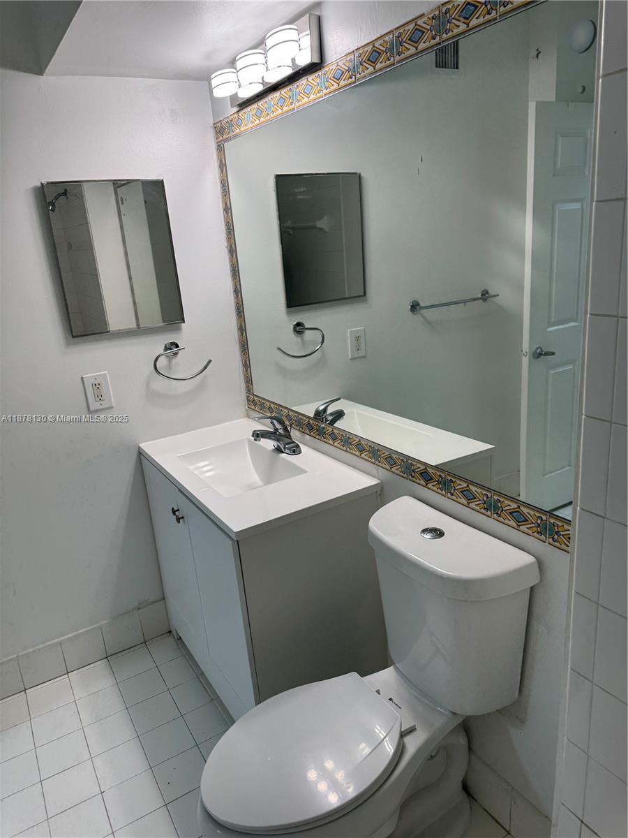 Pembroke Pines Pembroke Pines, FL 33024 - Photo 10 of 15 a bathroom with a toilet sink and mirror