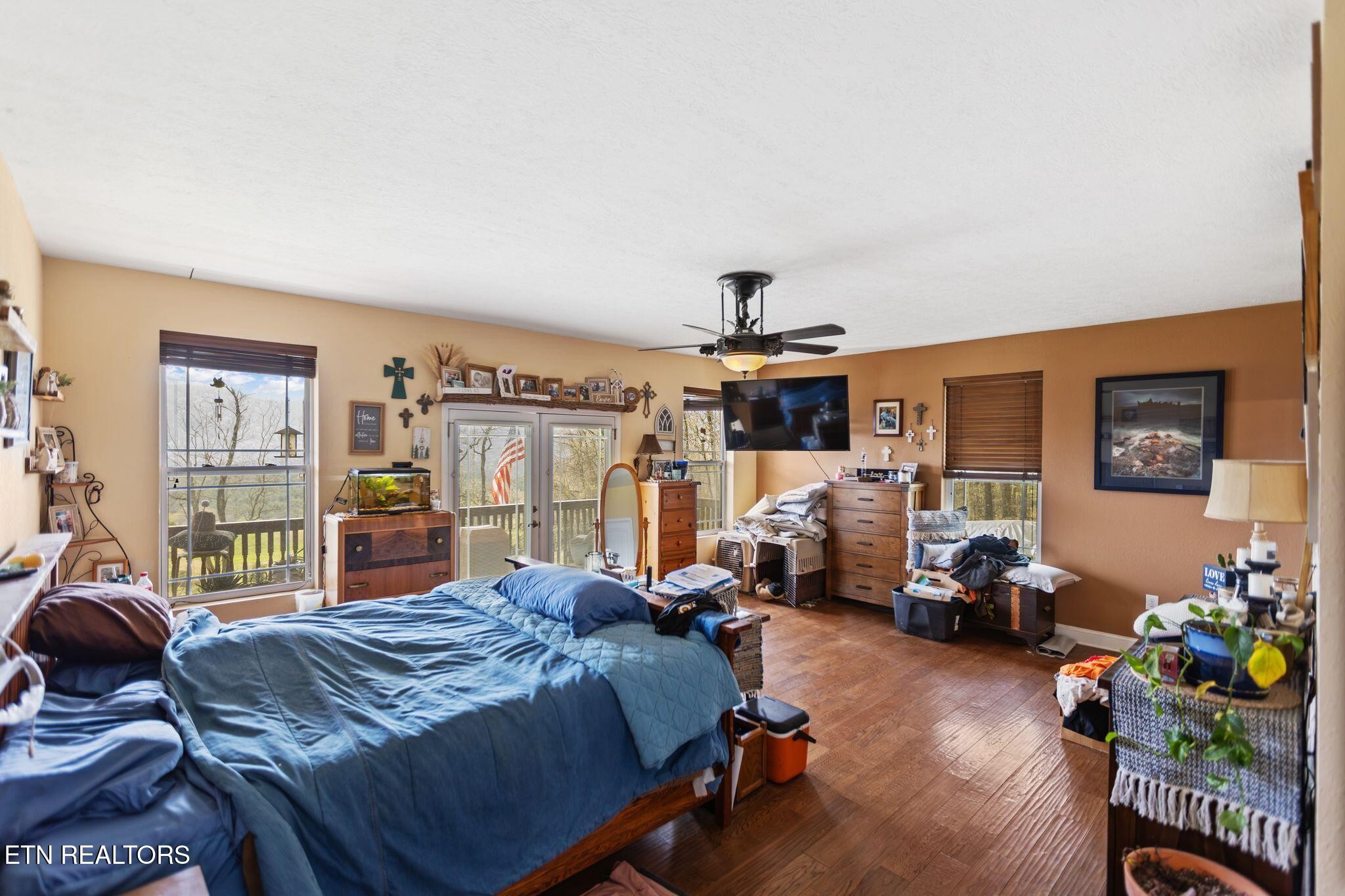 741 Clinch Valley Road Powder Springs, TN 37848 - Photo 12 of 50 a bed room with a bed and a large window