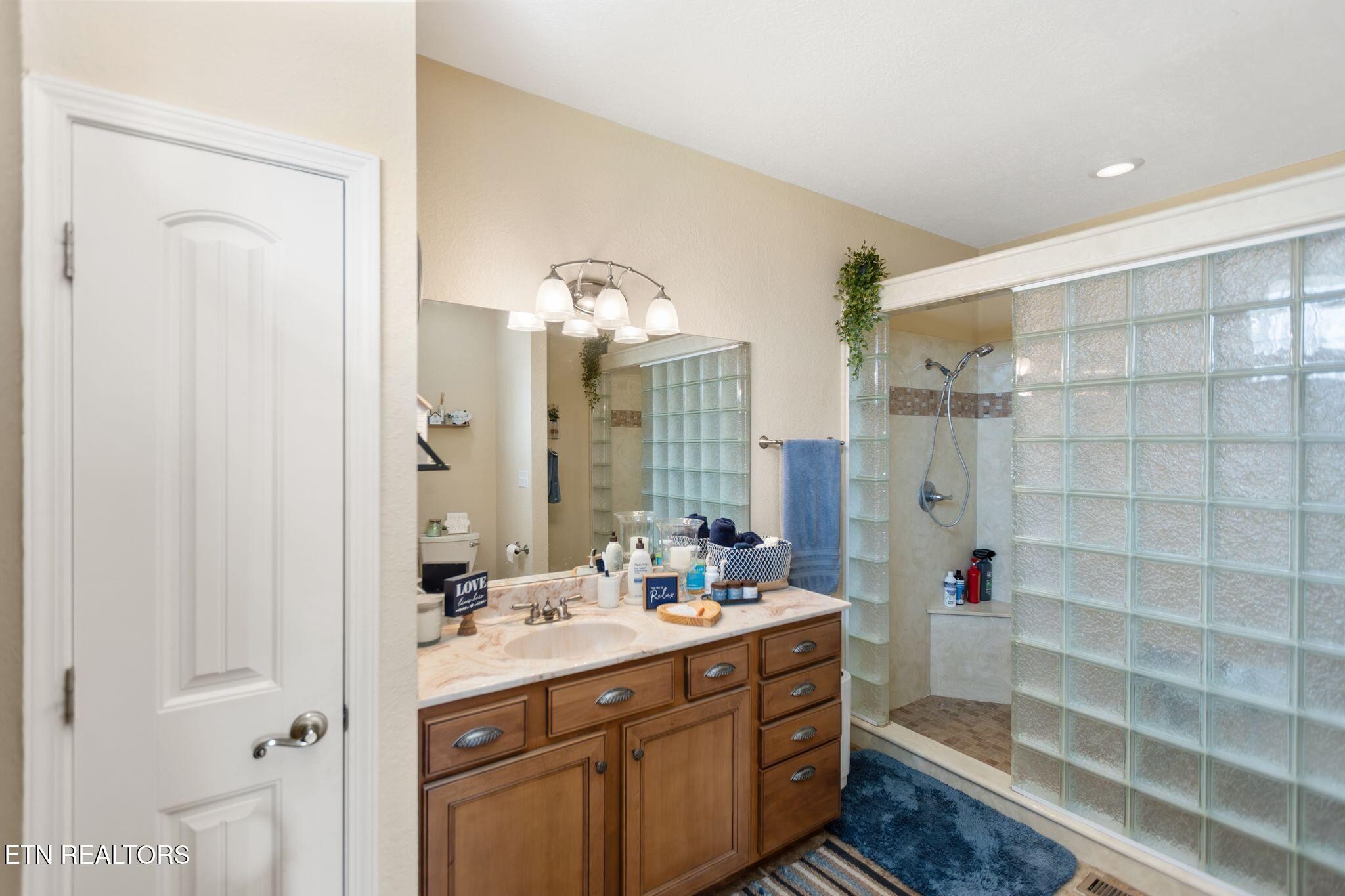 741 Clinch Valley Road Powder Springs, TN 37848 - Photo 16 of 50 a bathroom with a double vanity sink mirror and shower