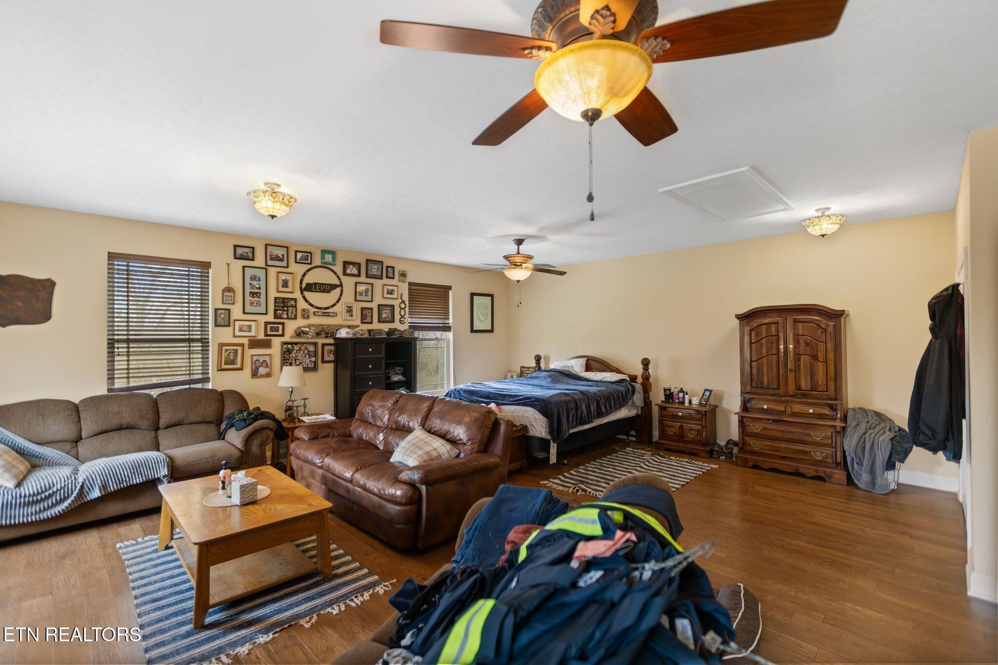 741 Clinch Valley Road Powder Springs, TN 37848 - Photo 29 of 50 a bedroom with furniture a ceiling fan and a window