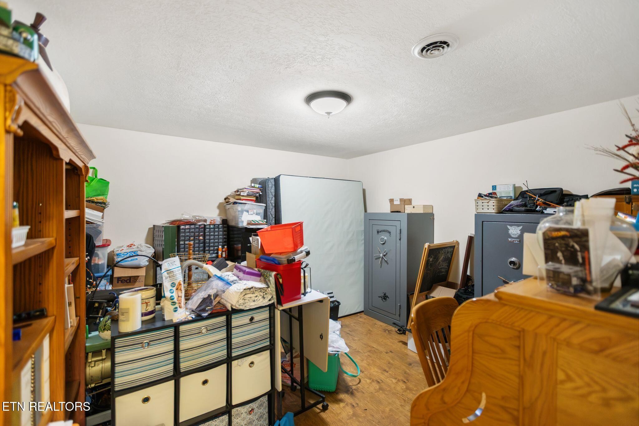 741 Clinch Valley Road Powder Springs, TN 37848 - Photo 32 of 50 a bedroom with a bed and wooden floor