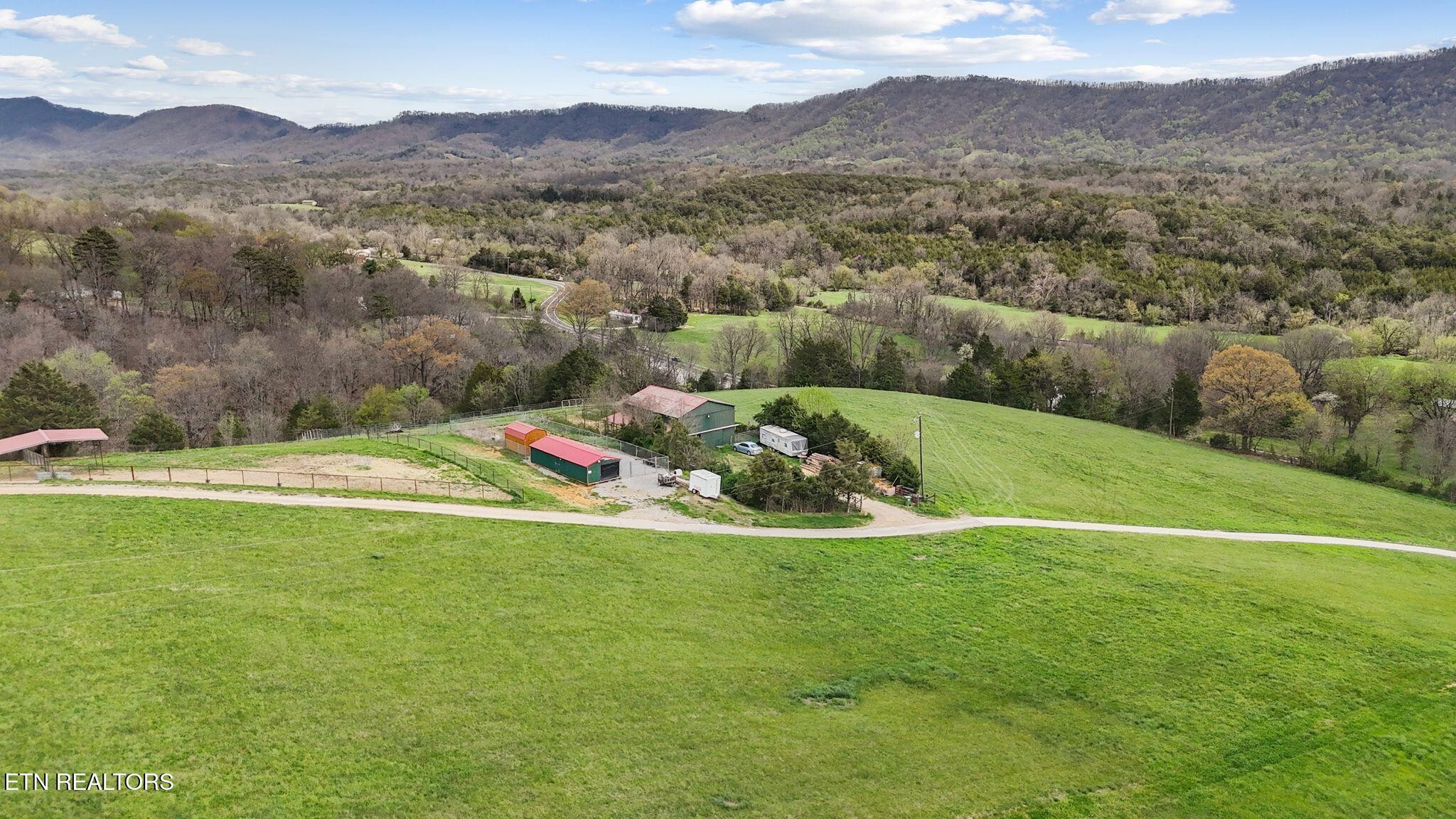 741 Clinch Valley Road Powder Springs, TN 37848 - Photo 37 of 50 a view of a lush green hillside next to a mountain