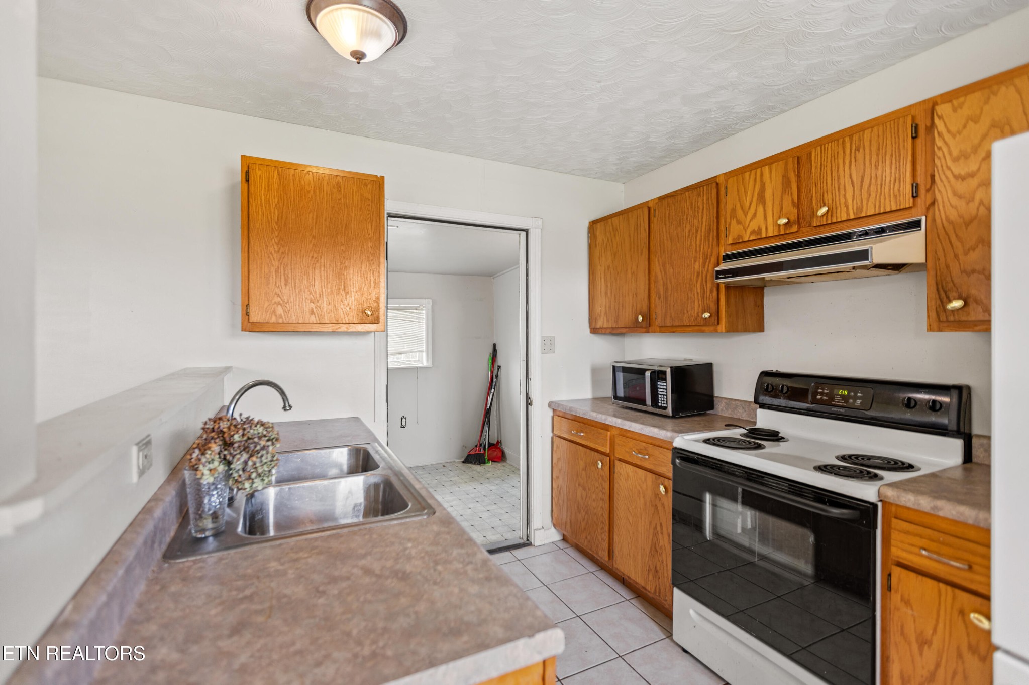 741 Clinch Valley Road Powder Springs, TN 37848 - Photo 45 of 50 a kitchen with stainless steel appliances granite countertop a stove and a sink