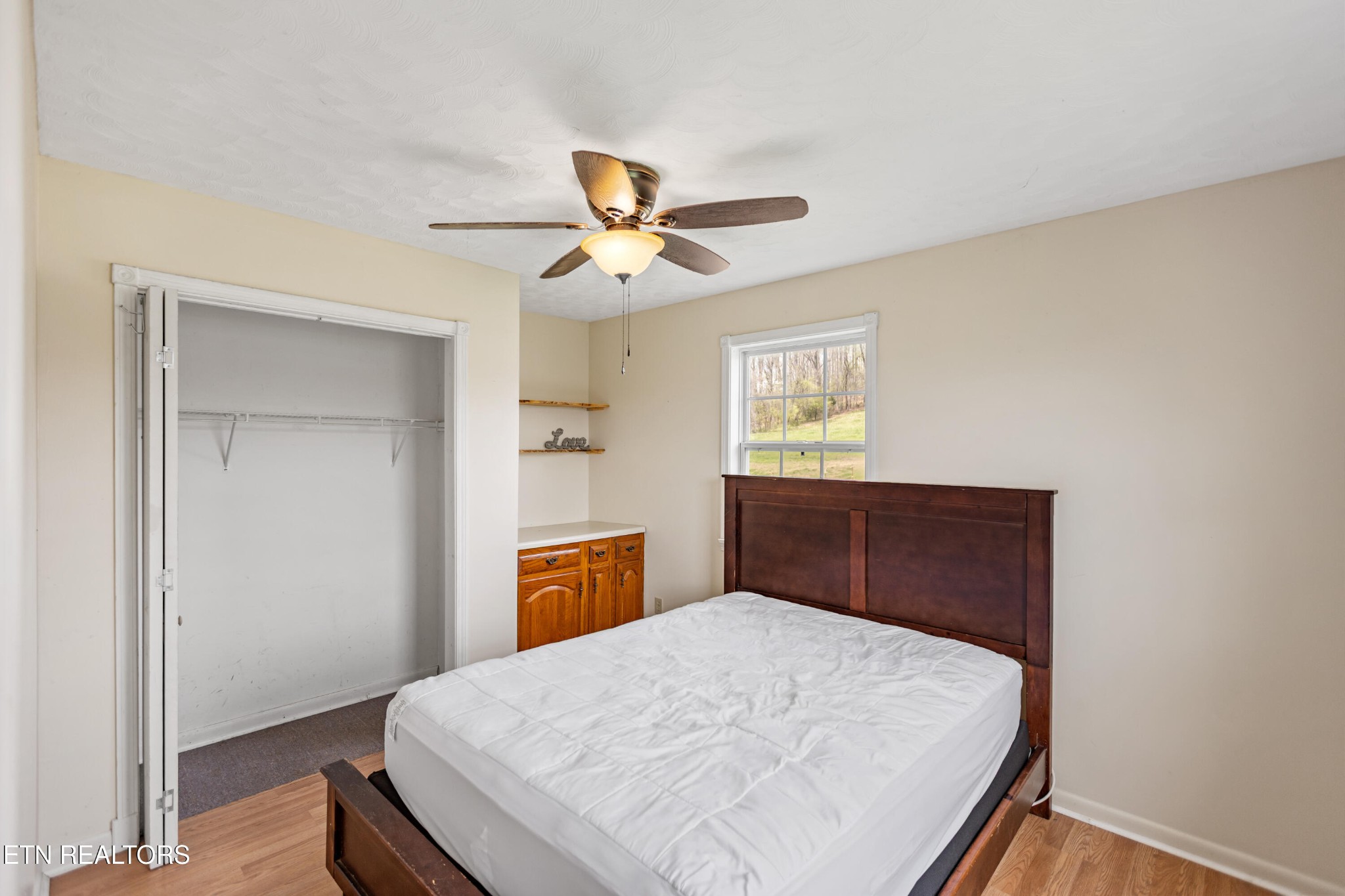 741 Clinch Valley Road Powder Springs, TN 37848 - Photo 46 of 50 a bedroom with a bed and a chandelier
