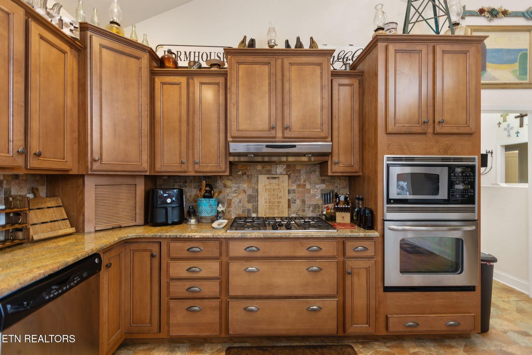 741 Clinch Valley Road Powder Springs, TN 37848 - Photo 10 of 50 a kitchen with stainless steel appliances granite countertop a refrigerator a stove and wooden cabinets