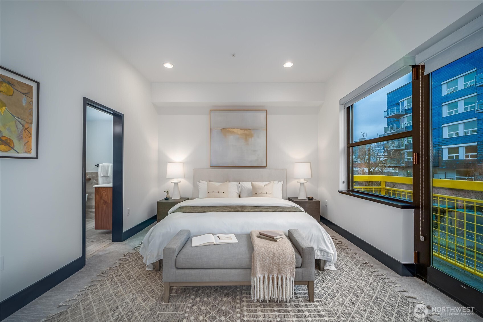 615 East Pike Street, Unit 303 Seattle, WA 98122 - Photo 14 of 40 a bedroom with a bed and glass door