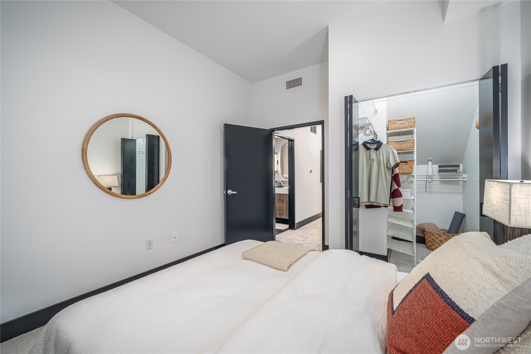 615 East Pike Street, Unit 303 Seattle, WA 98122 - Photo 27 of 40 a bedroom with a bed and a mirror