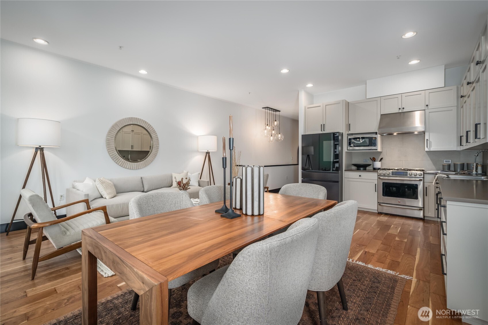 615 East Pike Street, Unit 303 Seattle, WA 98122 - Photo 8 of 40 a living room with stainless steel appliances furniture a rug and a kitchen view