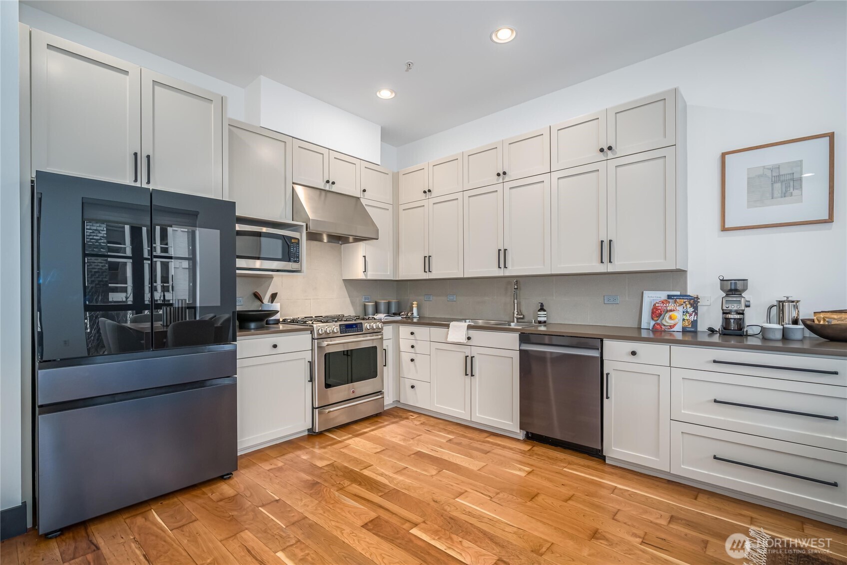 615 East Pike Street, Unit 303 Seattle, WA 98122 - Photo 9 of 40 a kitchen with stainless steel appliances granite countertop a stove sink and cabinets