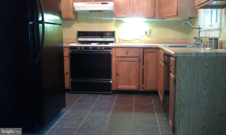 111 Homewood Road Linthicum Heights, MD 21090 - Photo 3 of 14 a kitchen with a sink a stove and cabinets