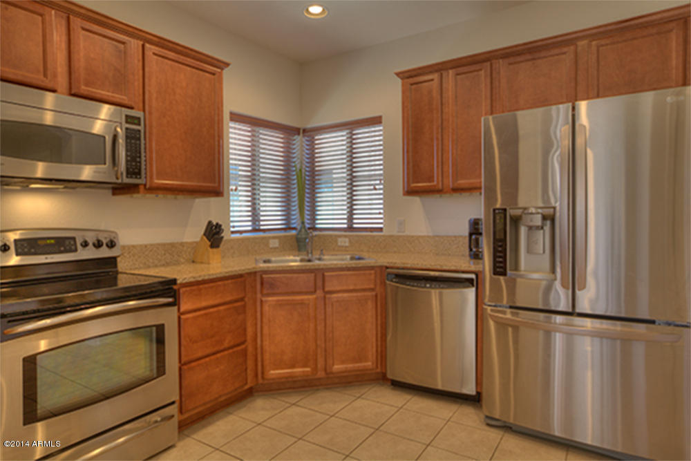 3935 East Rough Rider Road, Unit 1114 Phoenix, AZ 85050 - Photo 3 of 21 Kitchen w/ Stainless Steel and Granite