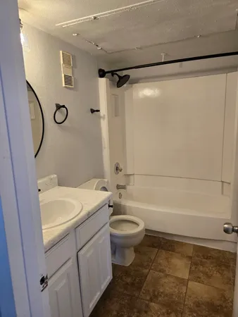 a bathroom with a sink a toilet and a shower
