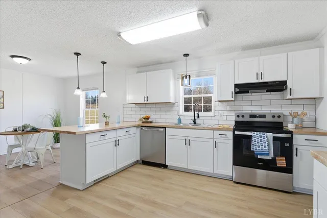 a kitchen with a stove top oven sink and cabinets