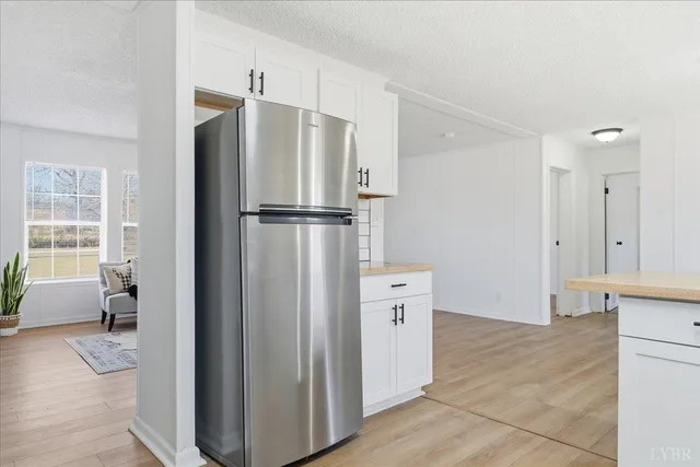 a kitchen with stainless steel appliances a refrigerator and a cabinets