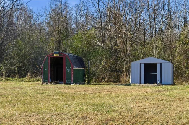 a view of a wooden door and a yard