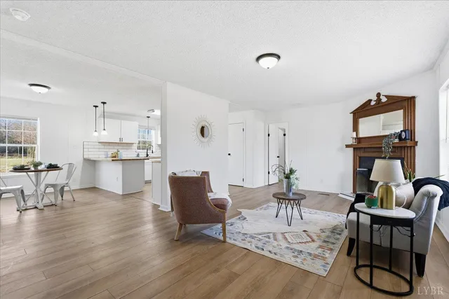 a living room with furniture a dining table and kitchen view