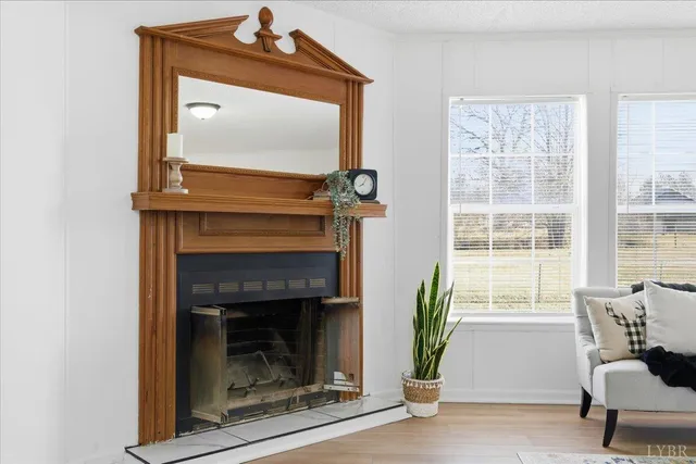 a living room with a fireplace and a window