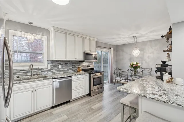 a kitchen with a sink stove and refrigerator