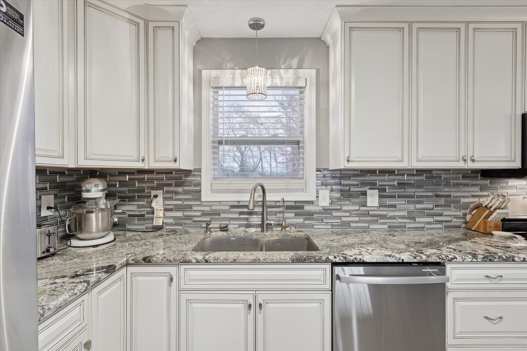 549 Bayfield Road Rockton, IL 61073 - Photo 12 of 47 a kitchen with stainless steel appliances granite countertop a sink a stove and cabinets