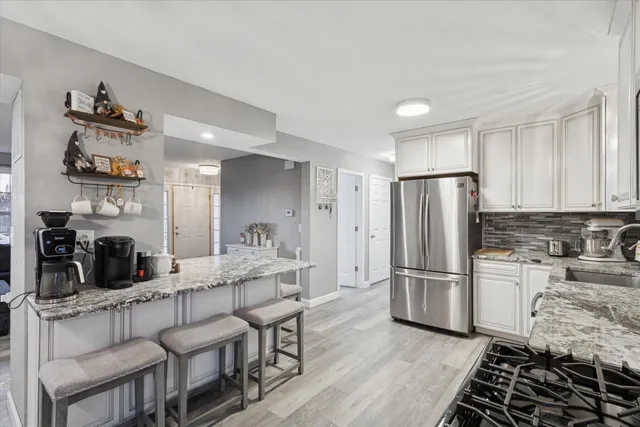 a kitchen with refrigerator and cabinets