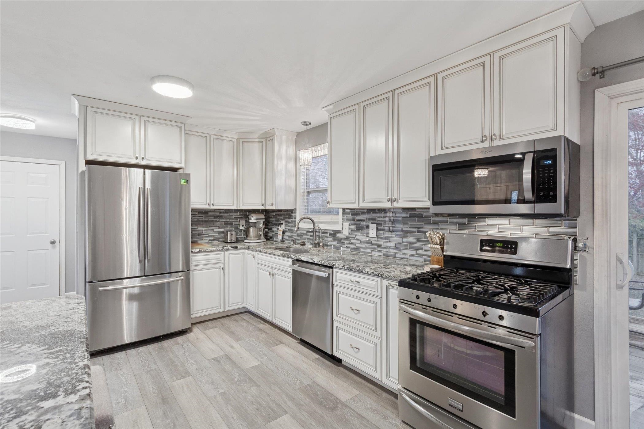 549 Bayfield Road Rockton, IL 61073 - Photo 15 of 47 a kitchen with cabinets stainless steel appliances and wooden floor