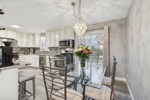 a view of a dining room with furniture and chandelier