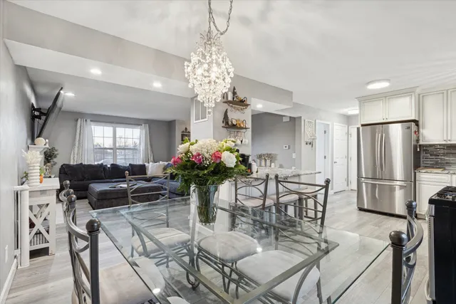 a view of a dining room with furniture and a chandelier