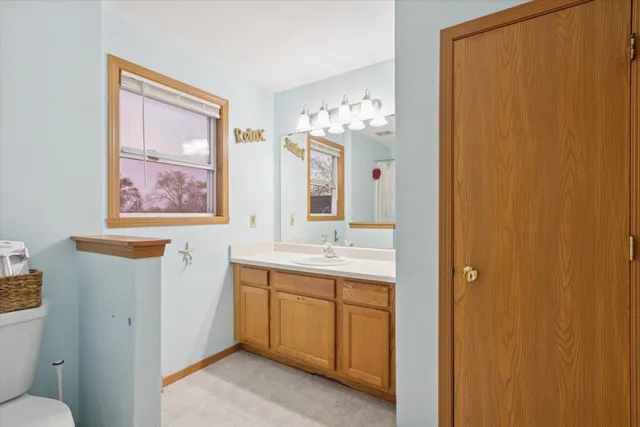 a bathroom with a sink a mirror and a toilet